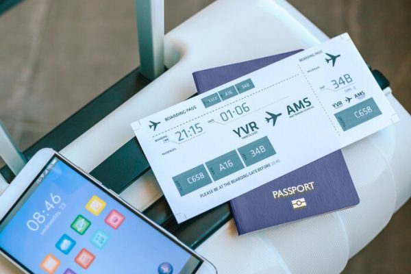 suitcase with air ticket passport and cell phone air ticket